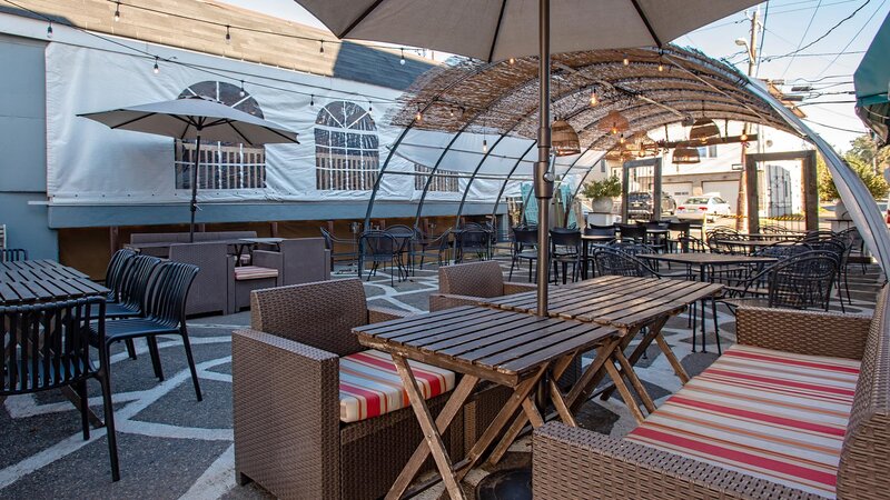 Patio seating area with tables under umbrellas